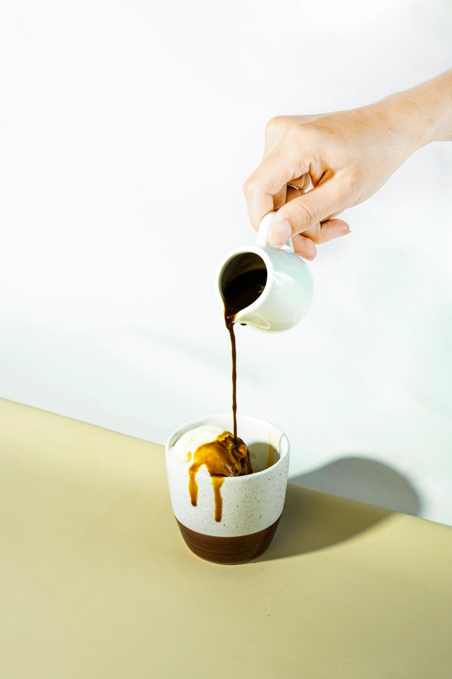 Affogato beim eingießen von Espresso über Vanilleeis